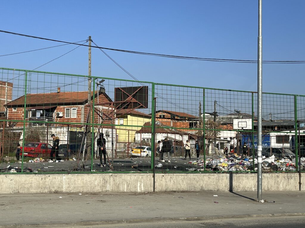 kids at a basketball court with trash